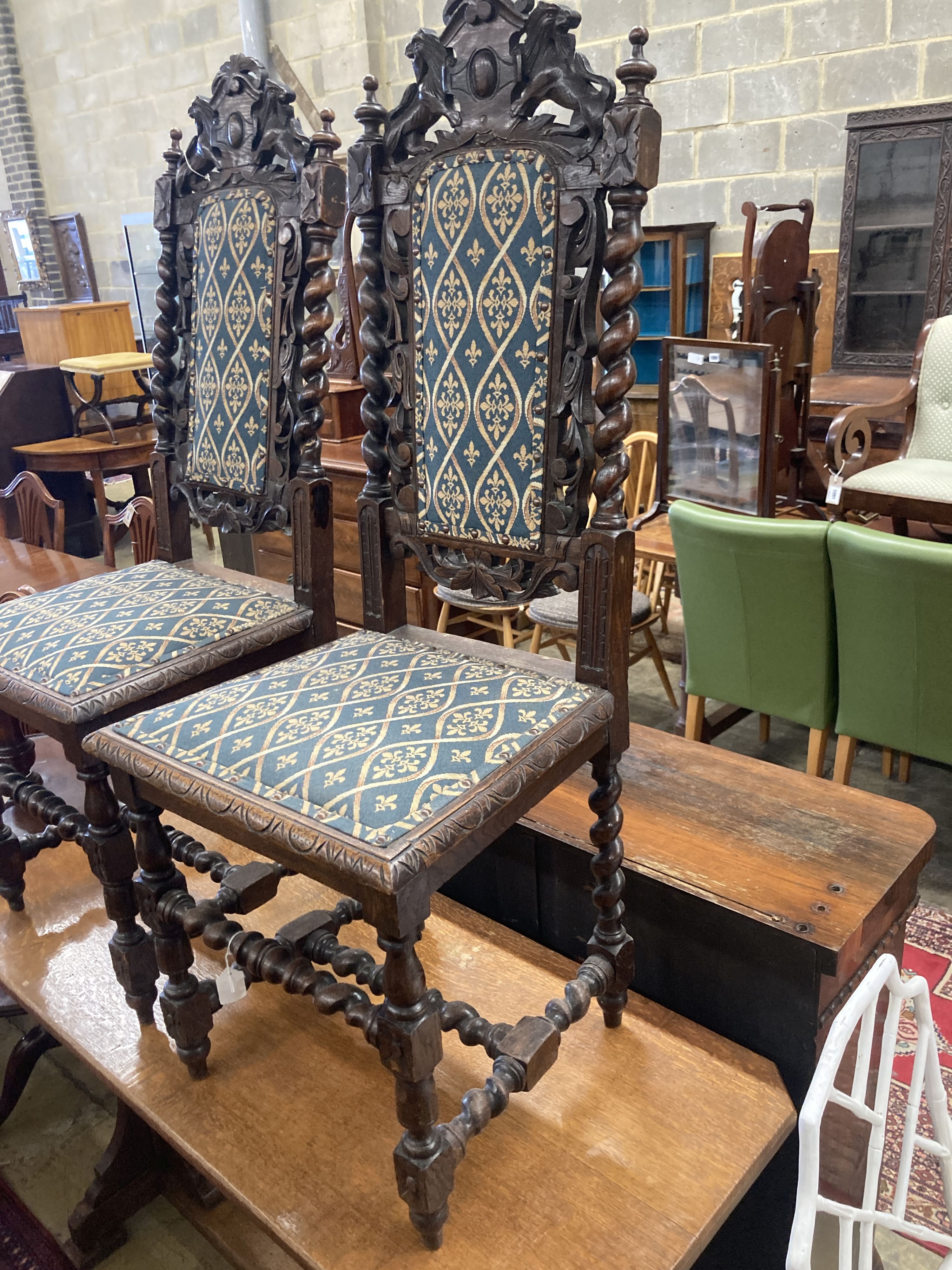 A pair of late 19th century Flemish carved oak panel backed dining chairs